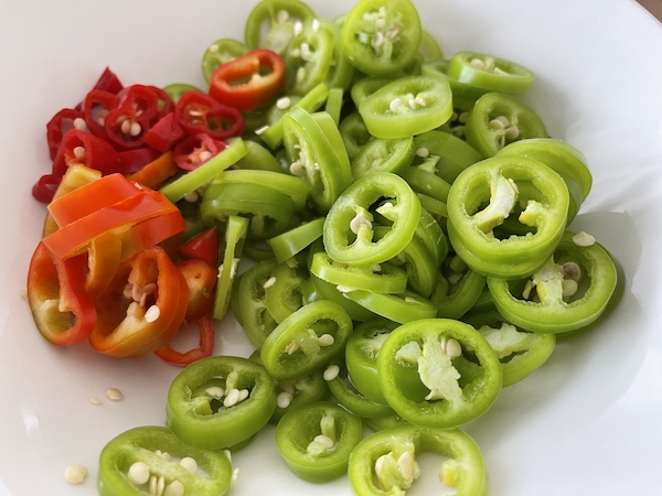 Siivutettuja jalapenoja leikkuulaudalla